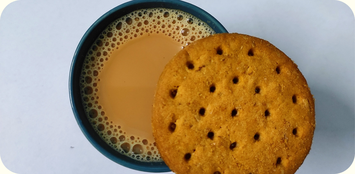 A cup of chai and a biscuit